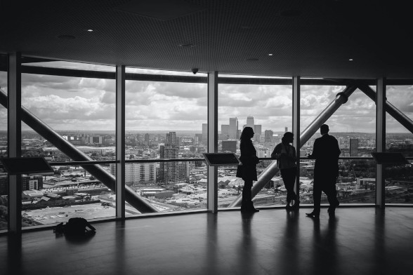 Some executives discussing business on an upper floor of a building.